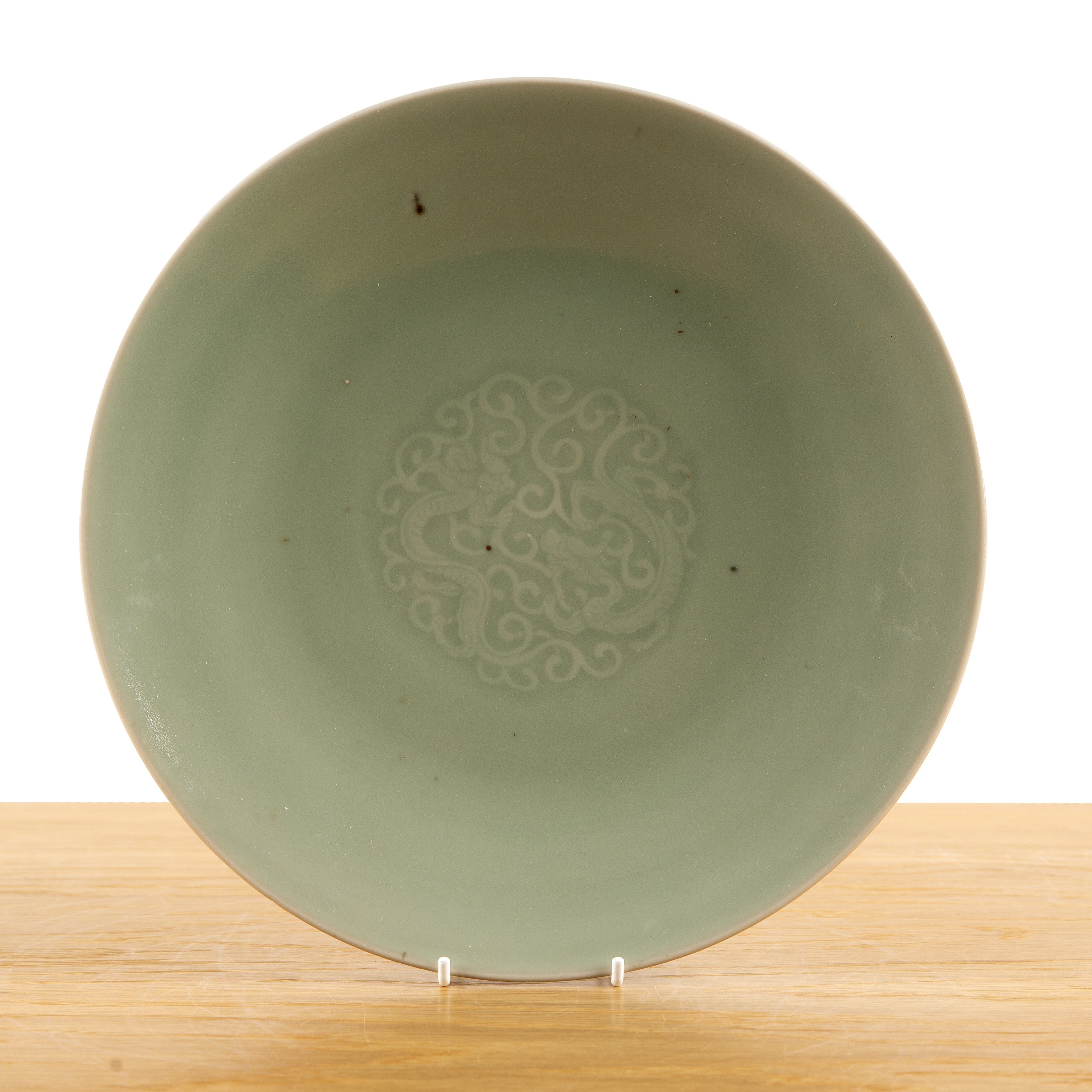 Celadon dish Chinese, 18th/19th Century with a central design of two chi-long dragons, and blue