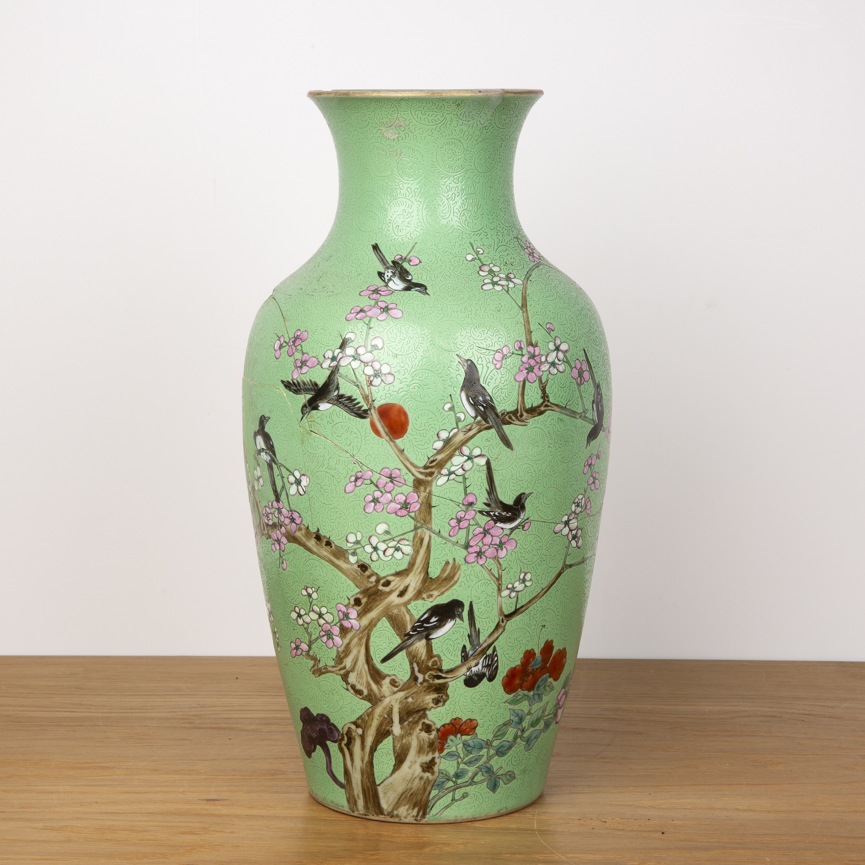 Green and enamel vase Chinese, 19th Century painted with birds and blossom on a an incised ground,