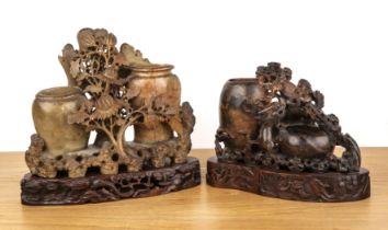 Two soapstone carvings Chinese each with a carved wood stand, 26cm and 19cm high (2) Both with