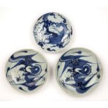 Three blue and white porcelain dragon dishes Chinese, 18th/19th Century one with a double circle