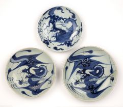 Three blue and white porcelain dragon dishes Chinese, 18th/19th Century one with a double circle