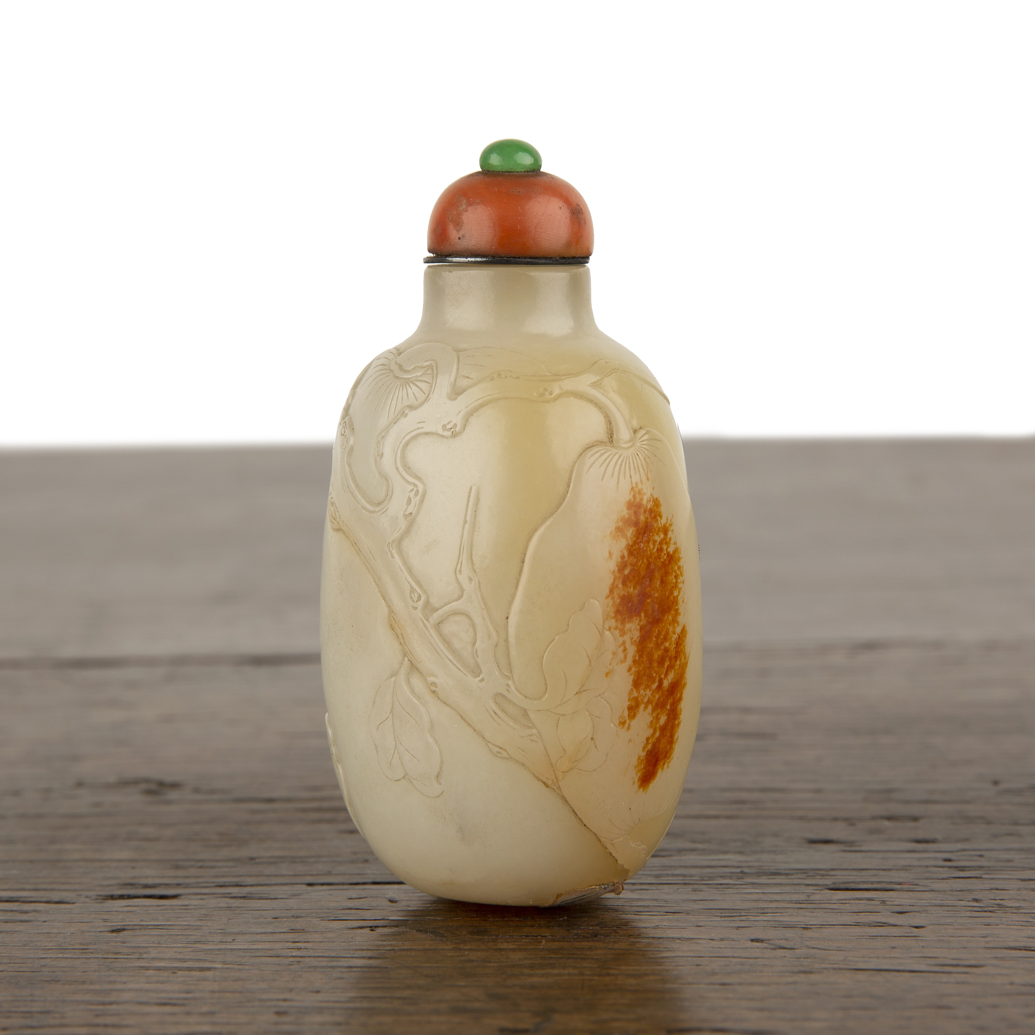 Nephrite snuff bottle Chinese, 1750-1780 of rounded elongated pebble shape carved in low relief