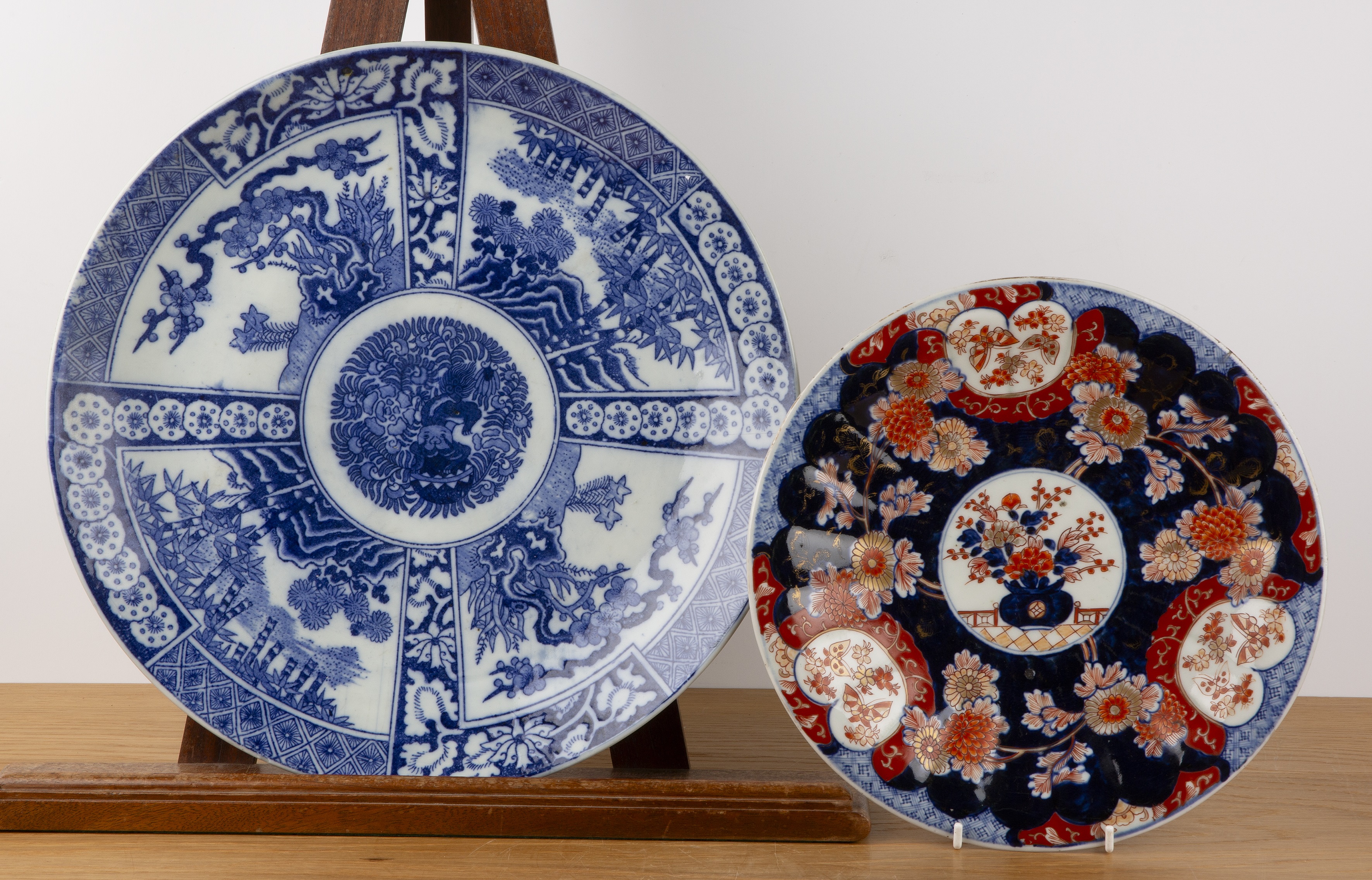 Two Imari circular chargers Japanese including a polychrome dish with a central vase of flowers,
