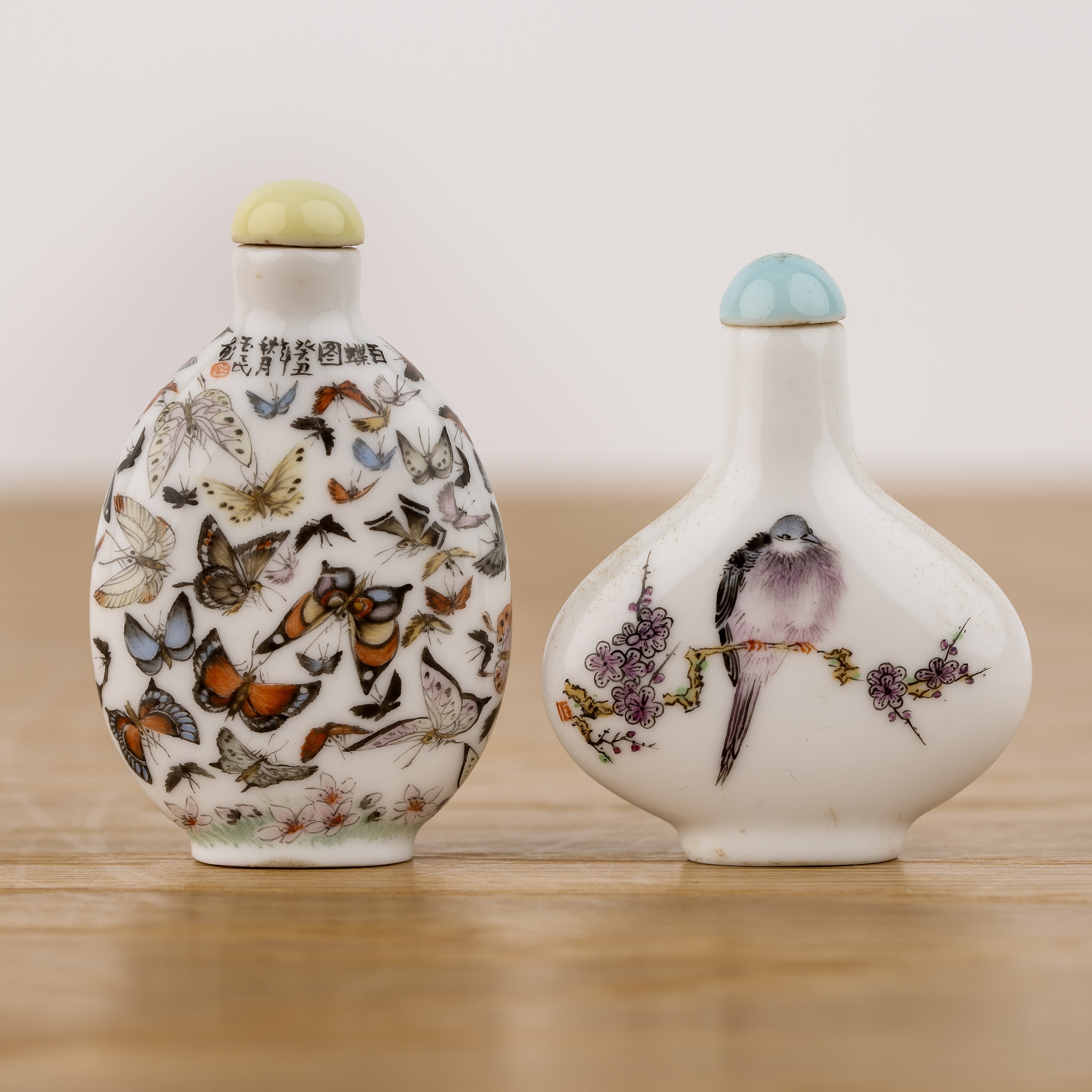 Two porcelain snuff bottles Chinese, 20th Century painted with butterflies, signed and inscribed and