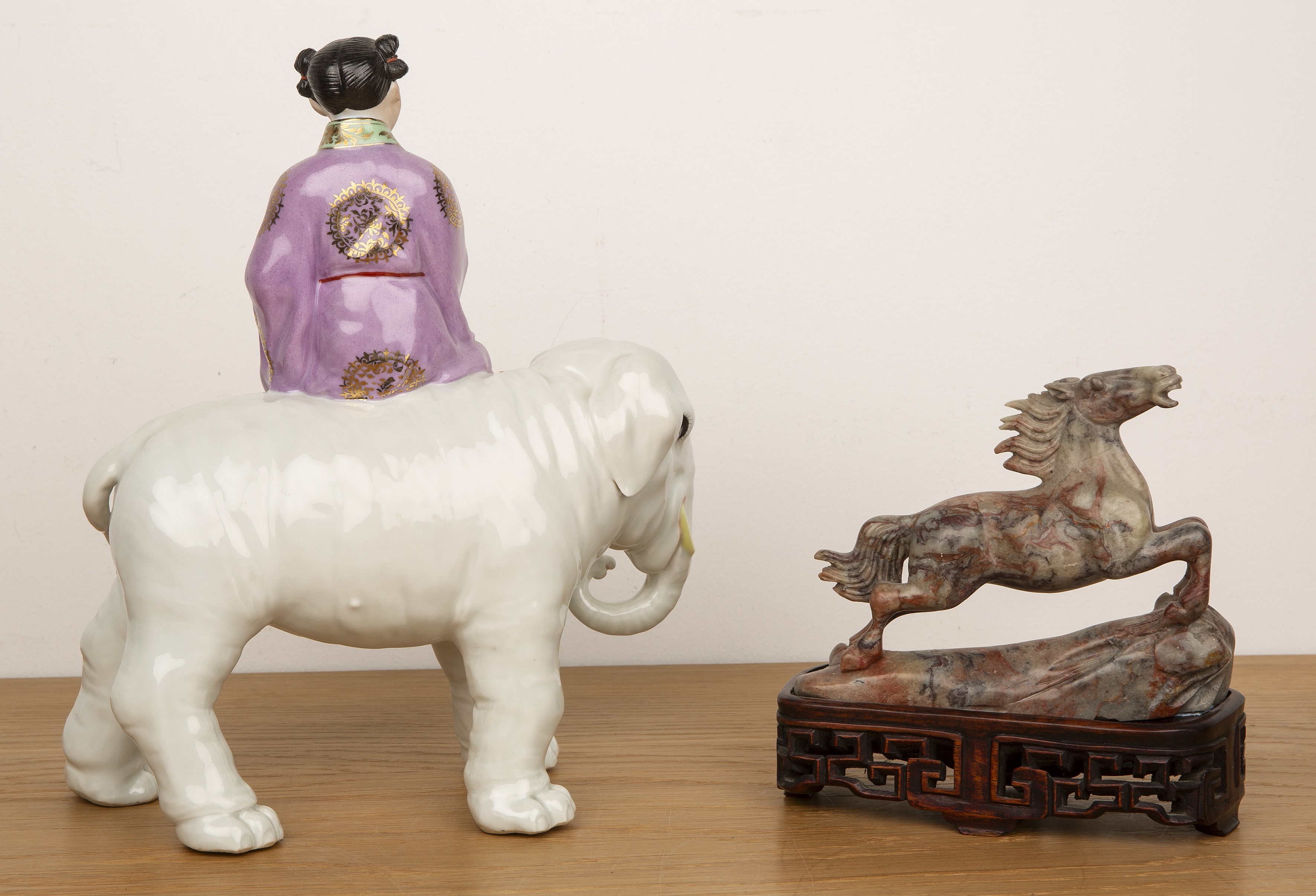 Porcelain model of an elephant and a girl Chinese, mid-20th Century the seated figure holding a - Image 2 of 4
