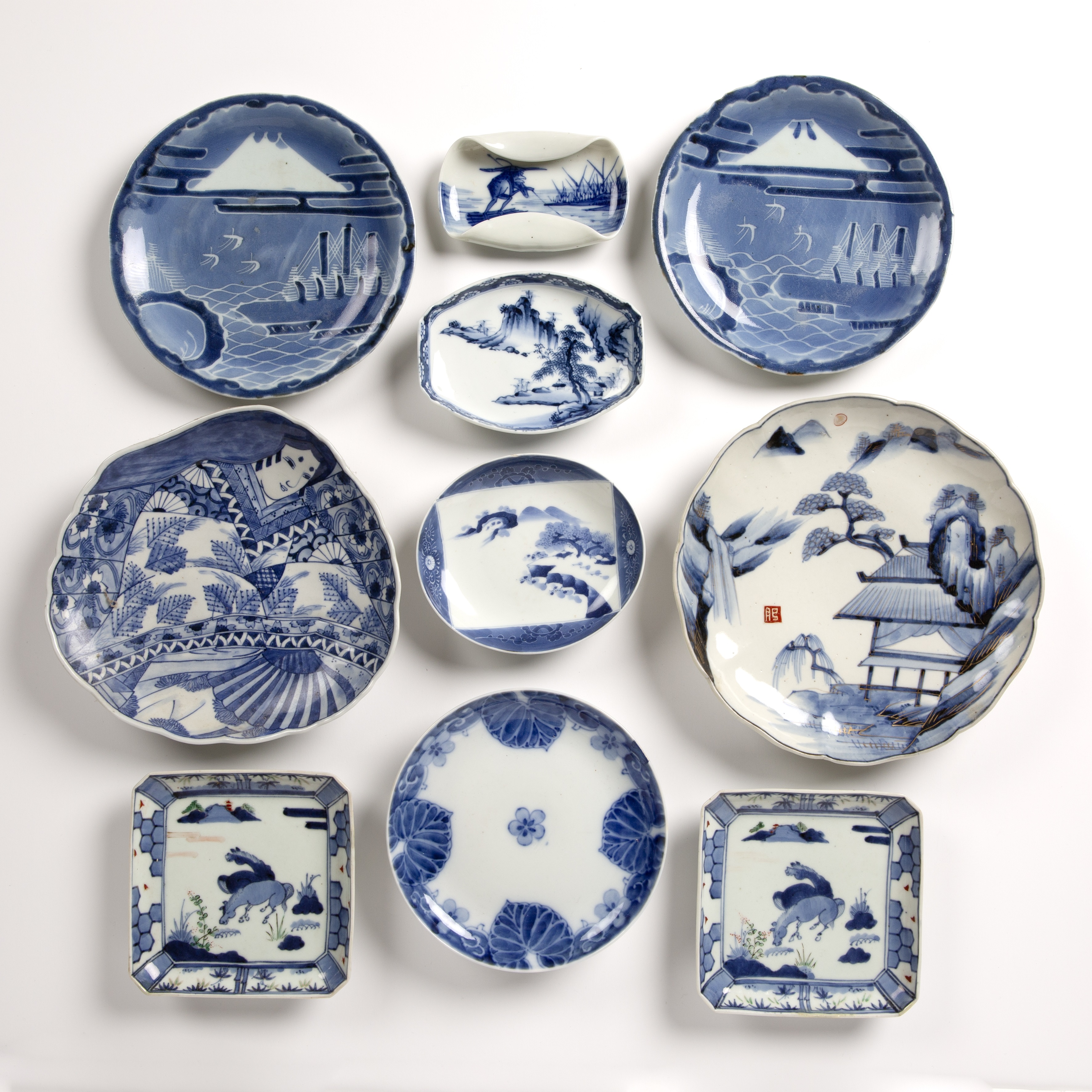 Group of Arita and Imari dishes Japanese including a pair of square dishes, painted with horses,