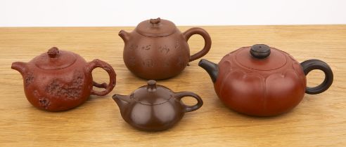 Collection of four Yixing teapots Chinese including a plain small circular example with seal mark,