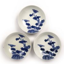 Three Hirado blue and white bowls Japanese, 19th Century painted with flowers and rock work, 20.