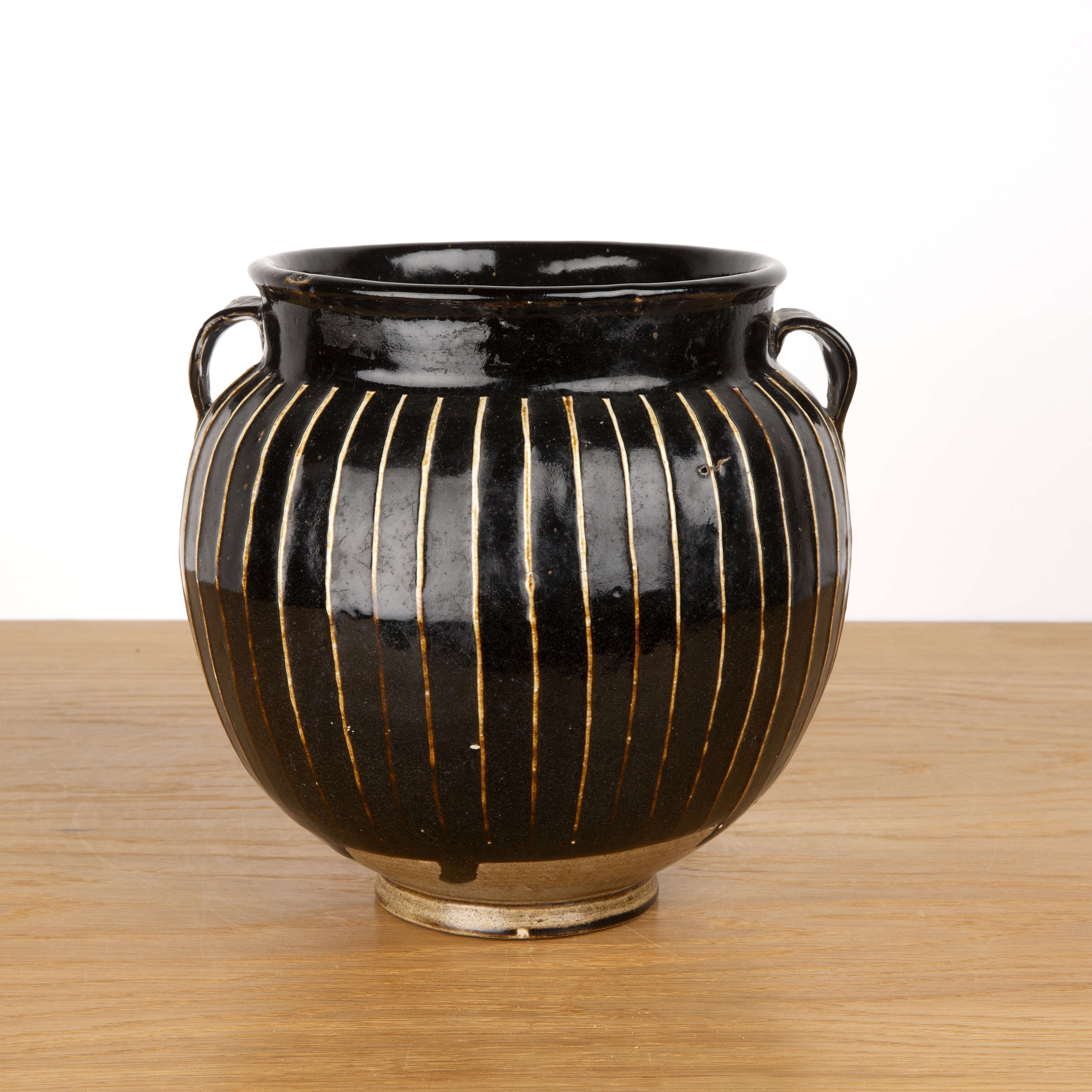 Treacle glazed two handled vase Chinese, 19th Century of reeded form with a raised foot, 22cm high - Image 2 of 4