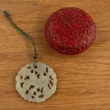 Cinnabar lacquer carved circular box and a jade pendant Chinese the pendant carved with a bird,