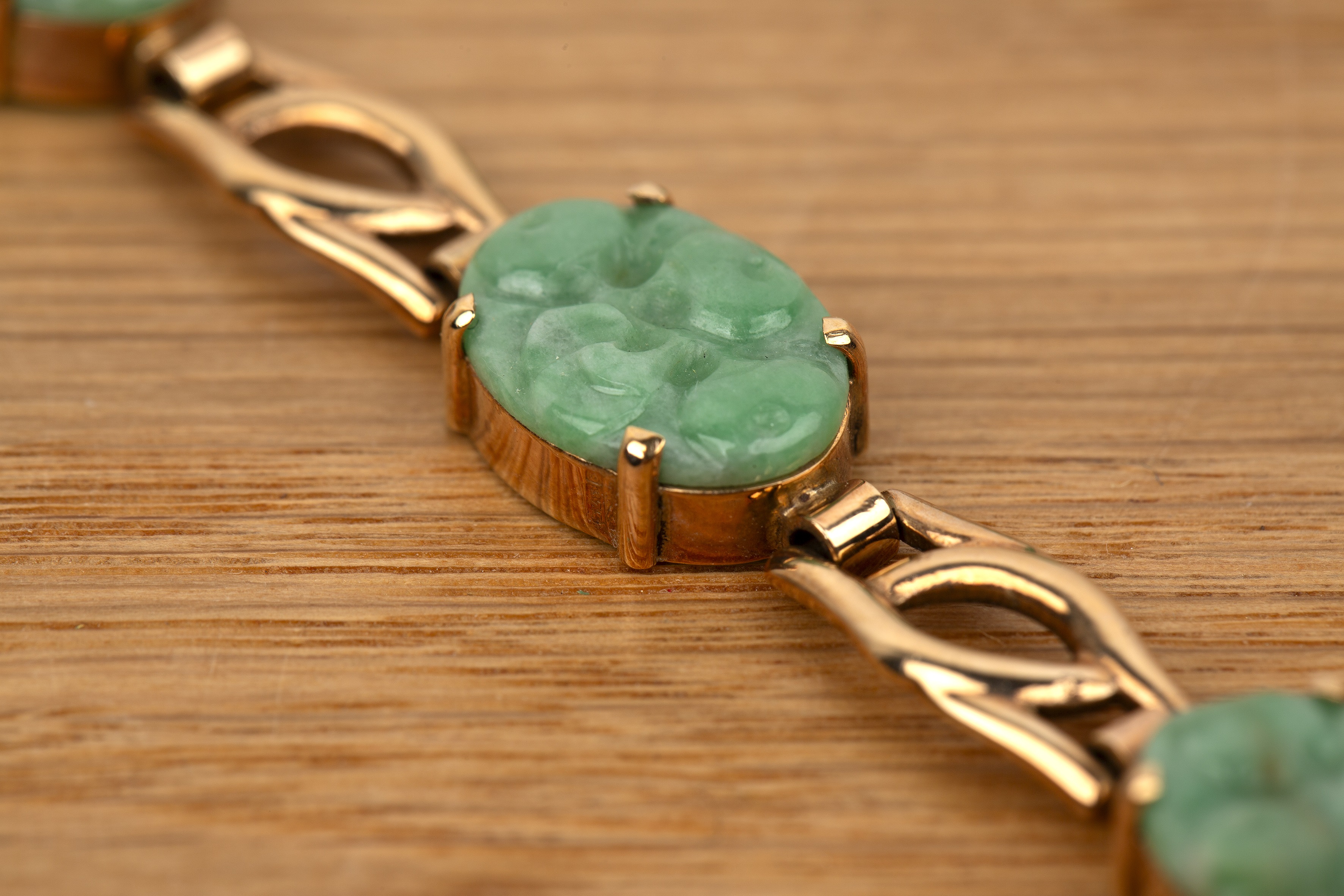 Two pieces of jade jewellery English, 20th Century the first a 9ct gold panel bracelet, set with six - Image 3 of 4