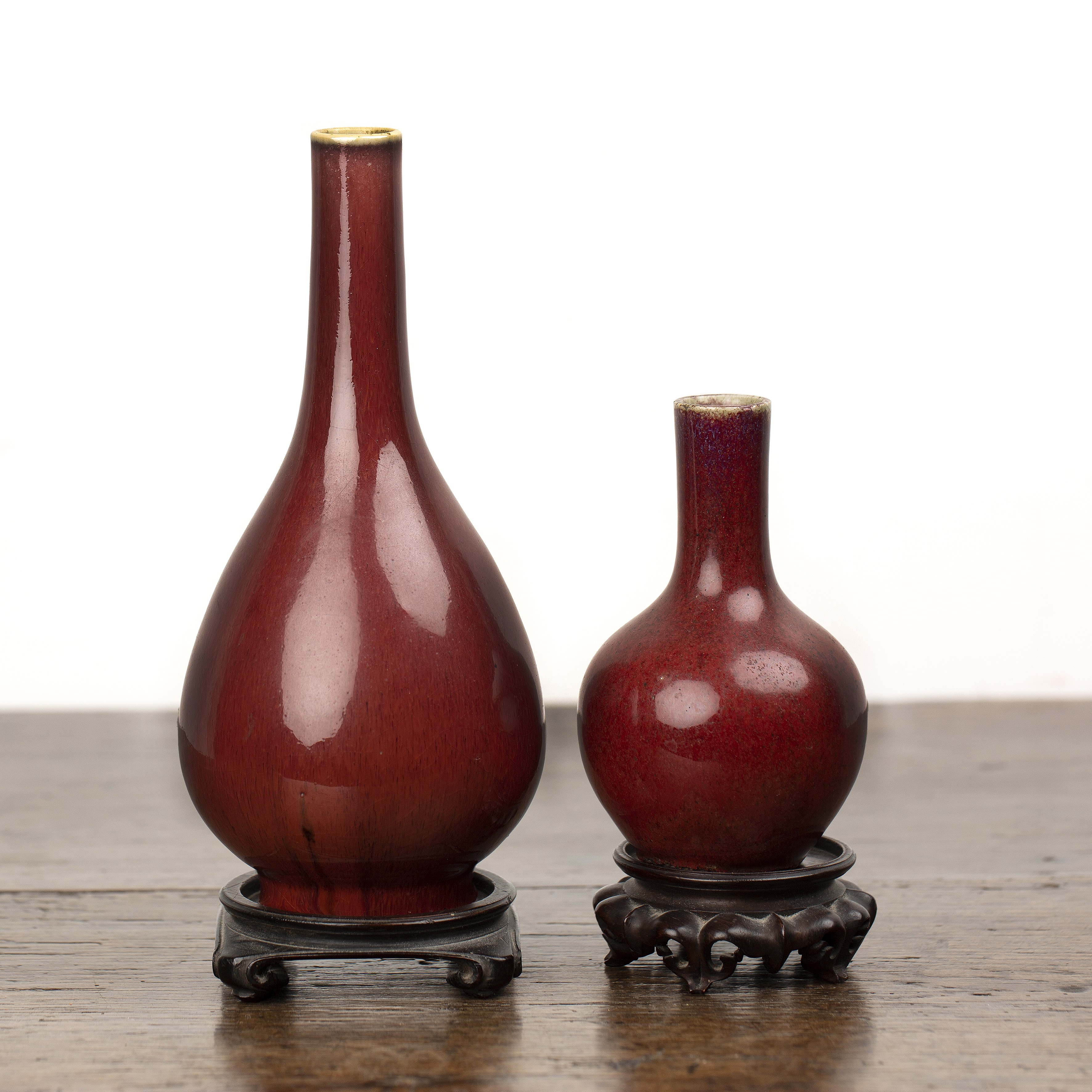 Two sang de boeuf vases on wooden stands Chinese, 18th/19th Century each of bottle vase form, 22.5cm - Image 2 of 5