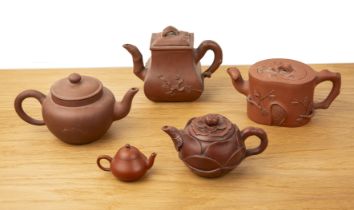 Group of five Yixing teapots Chinese, 19th/20th Century to include a rectangular teapot with moulded