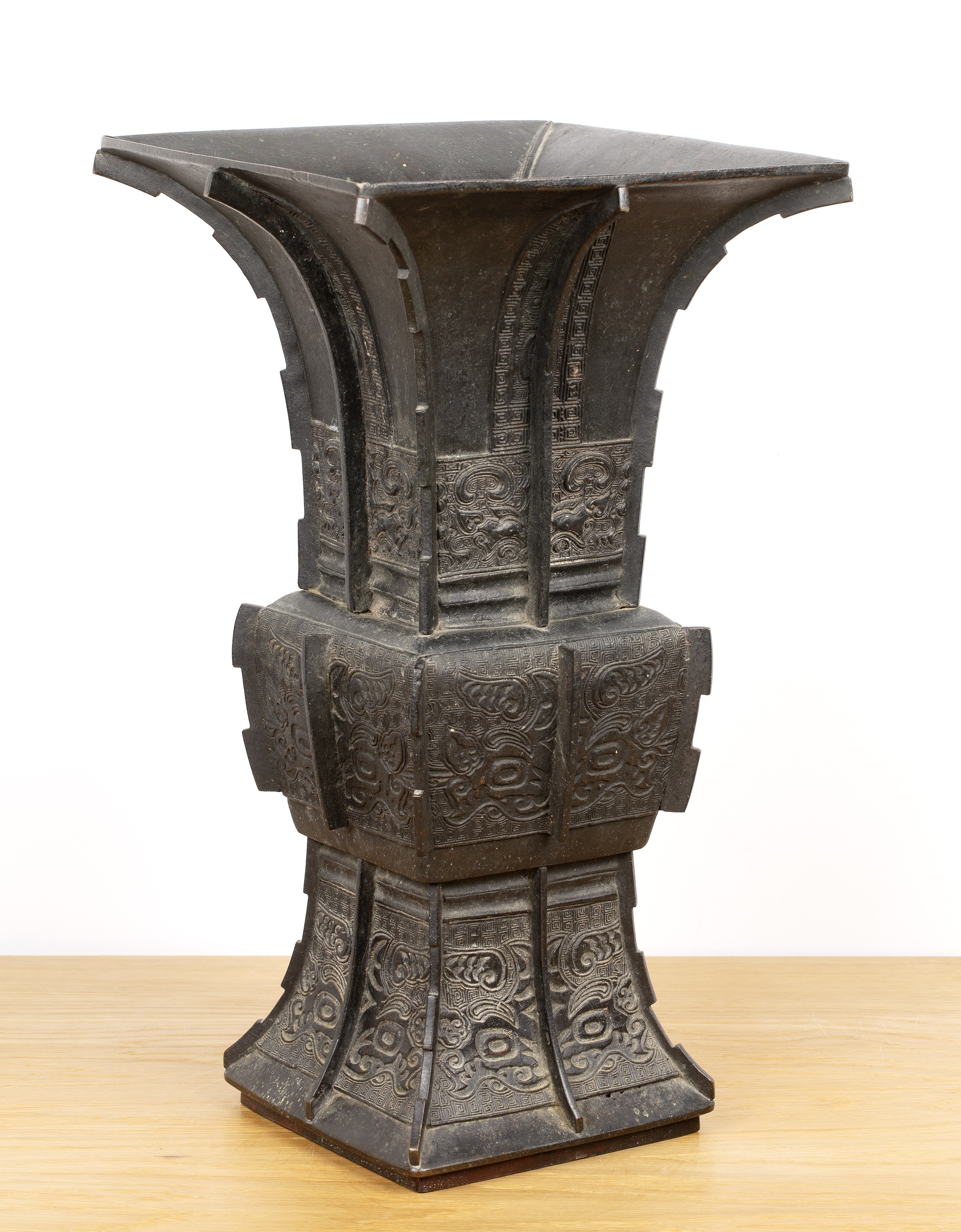 Large bronze archaic Gu form vessel Chinese, 19th Century with raised bands, and panels of taotie