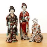 Two porcelain models of standing Geishas Japanese, circa 1900 one holding a cat, the other with