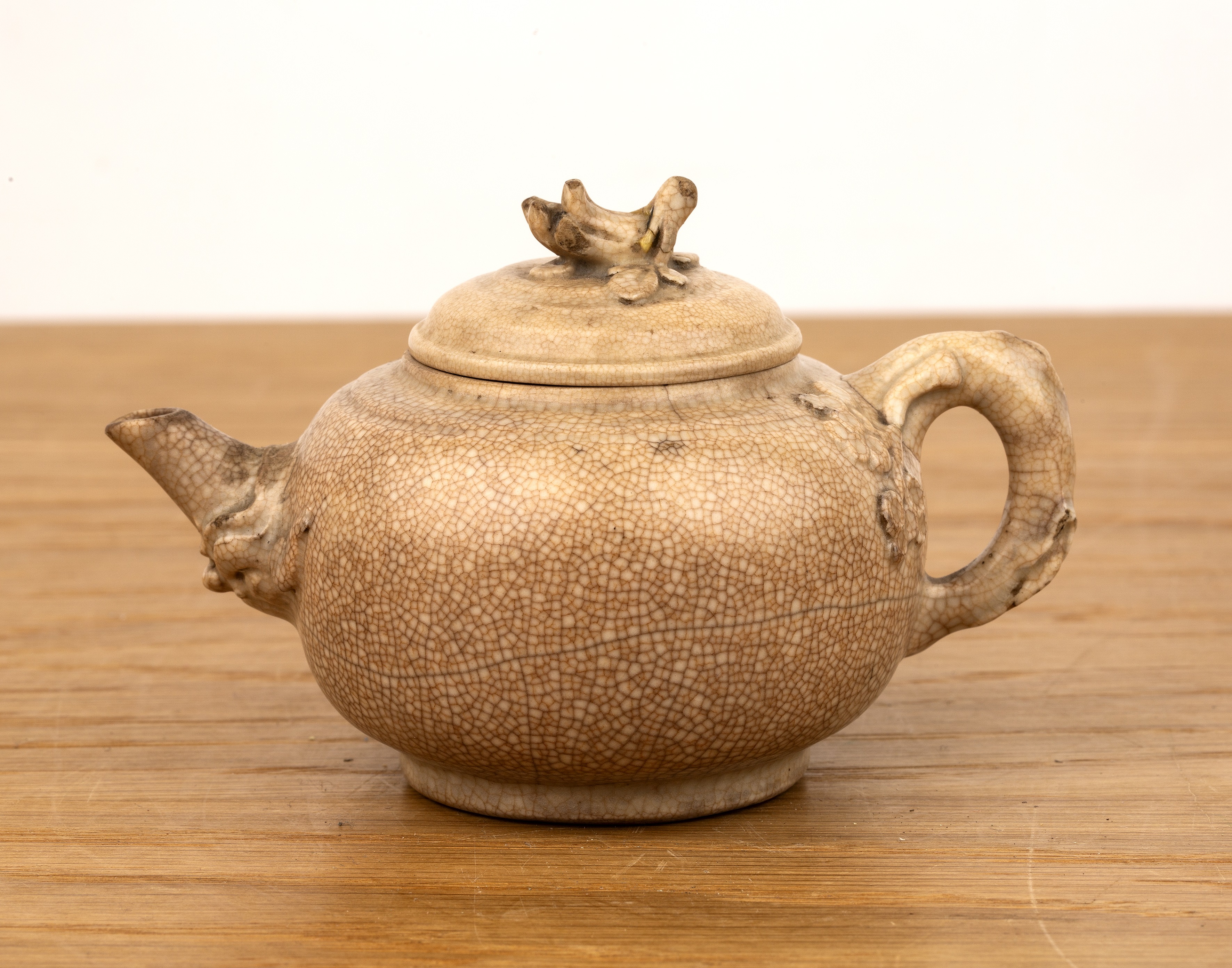 Small white glazed teapot Chinese, 18th Century with a bocage handle and leaf finial, 12cm long - Image 2 of 3