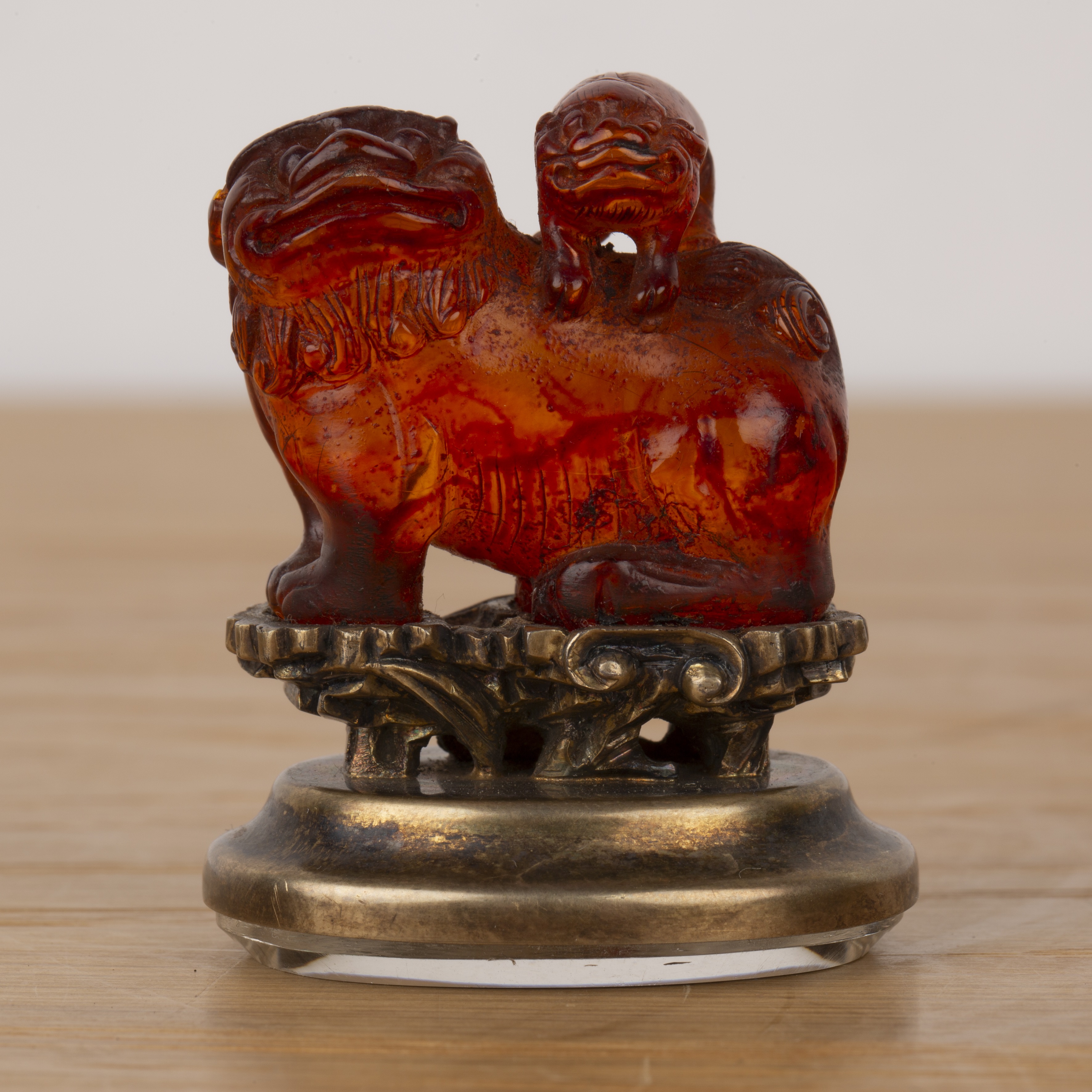 Amber kylin seal Chinese, 19th Century mounted on a metal and glass oval base, with a puppy on its - Image 4 of 13