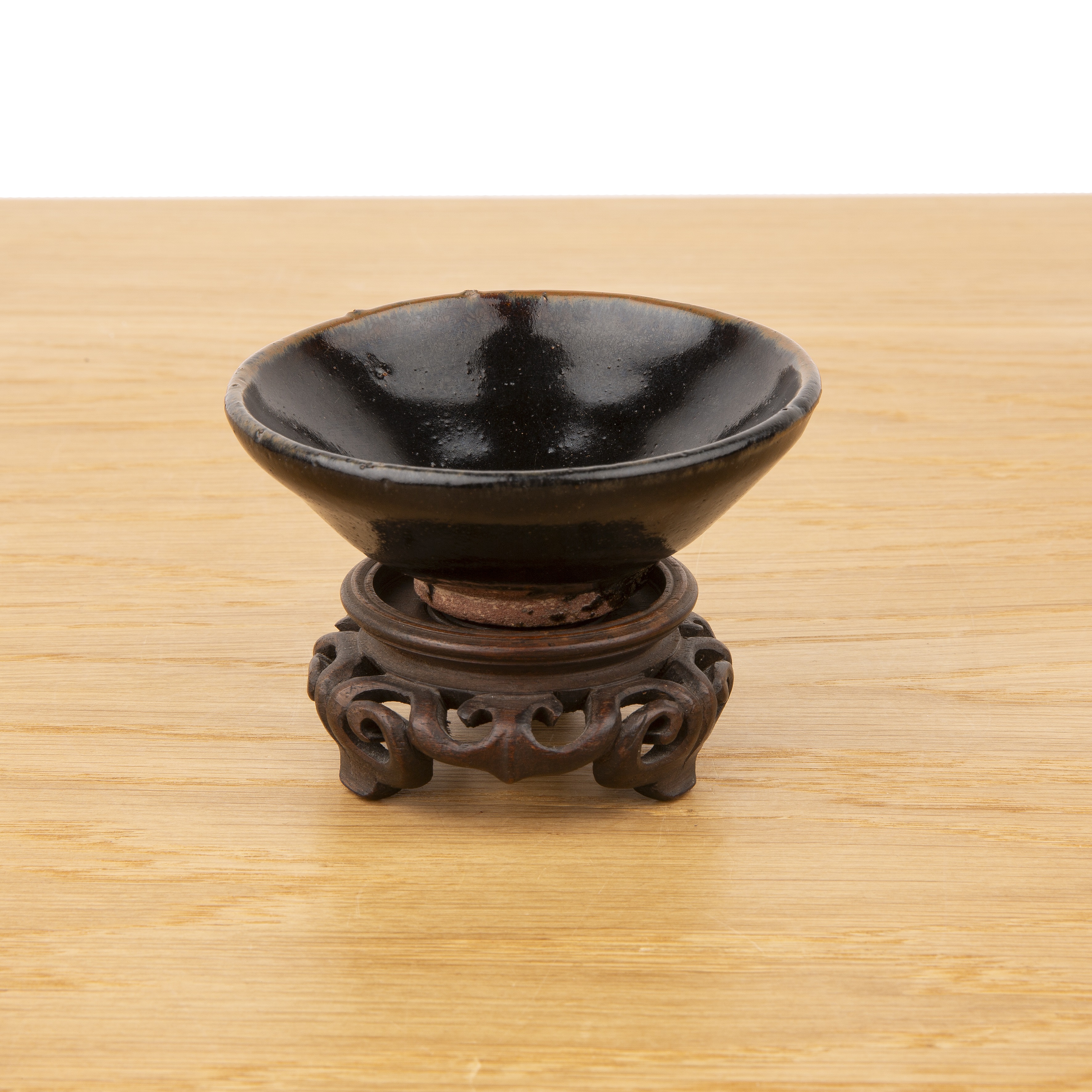 Tenmoku glaze small tea bowl Chinese of tapering plain form, with a small wooden stand, 9cm diameter