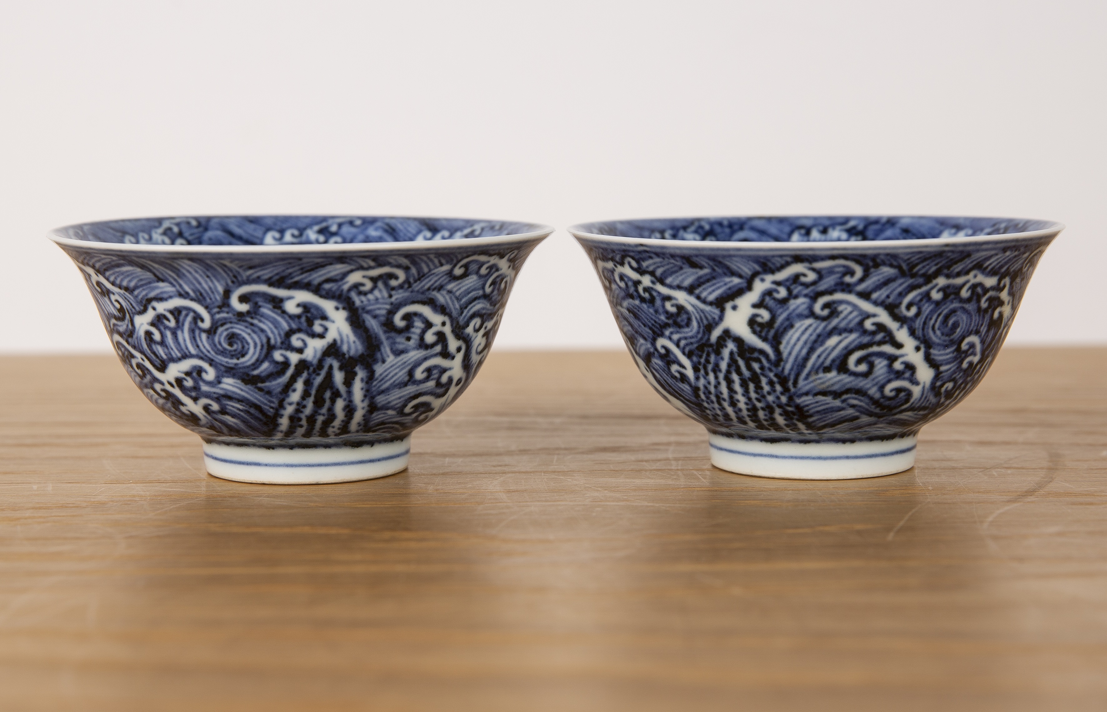 Pair of blue wave pattern bowls Chinese, 19th Century each on a raised foot with a single band, 10cm - Image 4 of 8