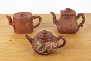 Yixing teapot and two others Chinese, 19th/20th Century including a circular teapot with a raised
