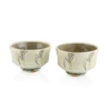 Mike Dodd (b.1943) A near pair of footed bowls stoneware with light green glaze and incised