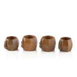 Robert Thompson of Kilburn (1876-1955) A set of four Mouseman napkin rings, circa 1970 oak carved