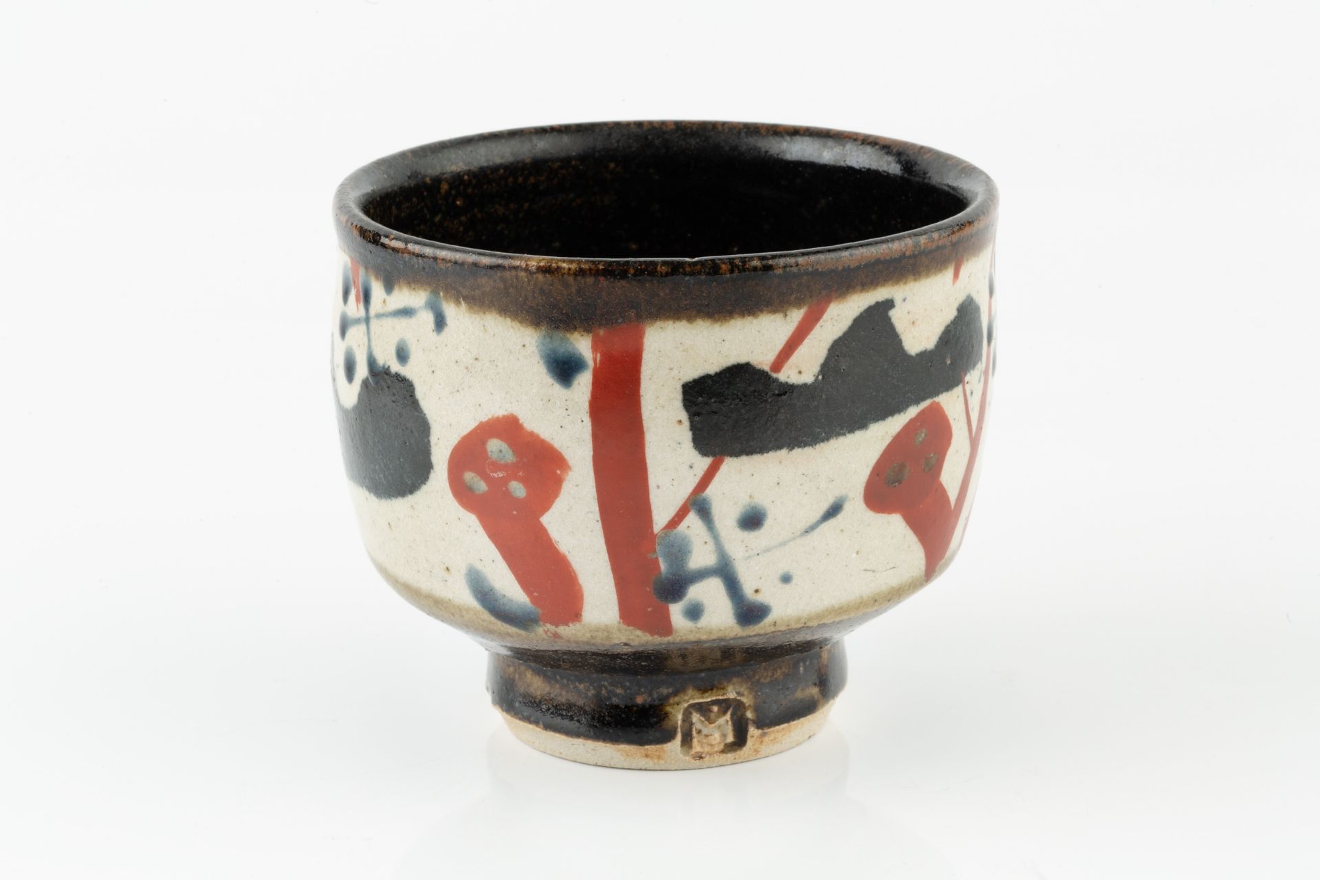 John Maltby (1936-2020) Footed bowl decorated with blue, red, and black abstract motifs on a cream - Image 2 of 3