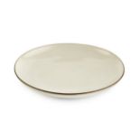 Lucie Rie (1902-1995) Dish cream glaze with manganese rim impressed potter's seal 14cm diameter.