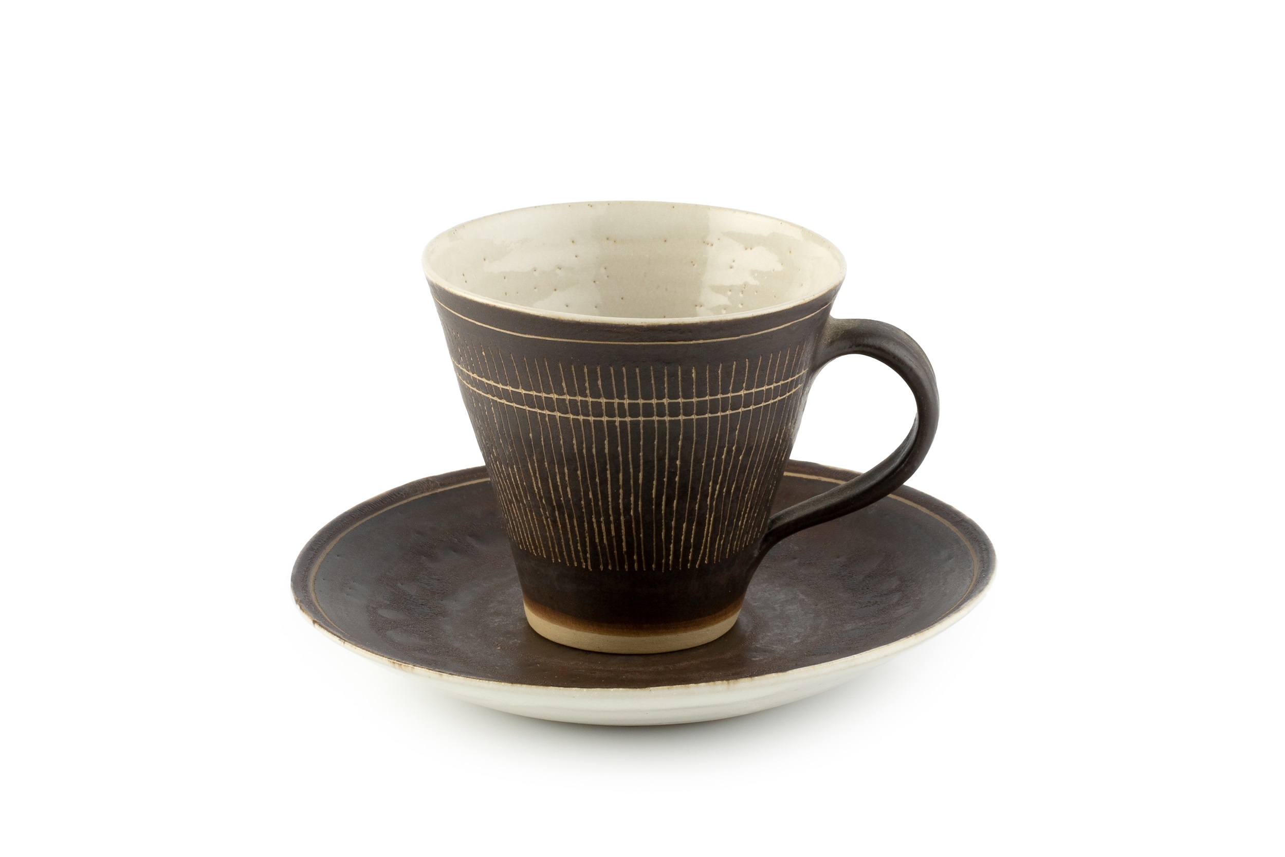 Lucie Rie (1902-1995) Cup and saucer manganese glaze, sgraffito decoration impressed potter's seal