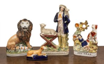 Four Staffordshire figures including lion and the lamb, unmarked, 25.5cm high, Staffordshire 'Dog