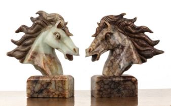 Bookends in the form of a horse's head carved hardstone, each engraved with markings, the largest