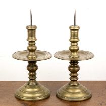 Pair of heavy bronze metal candlesticks South-East Asian, of turned form with drip trays, and