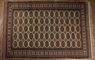 Afghan sofa carpet of cream/ivory ground with Bokhara style design, within a geometric border, 193cm