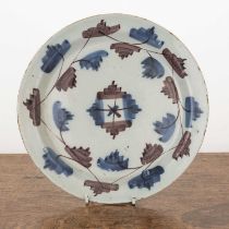 Delftware plate 18th Century, painted in manganese and blue, 22cm diameter With some chips and