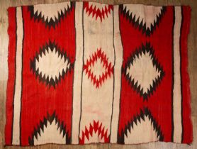 Navaho rug with geometric design circa 1920s, with bright red and pink stripes and a geometric