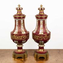 Pair of Sevres porcelain urns and covers 19th Century, with coronet finials, on red/pink ground,