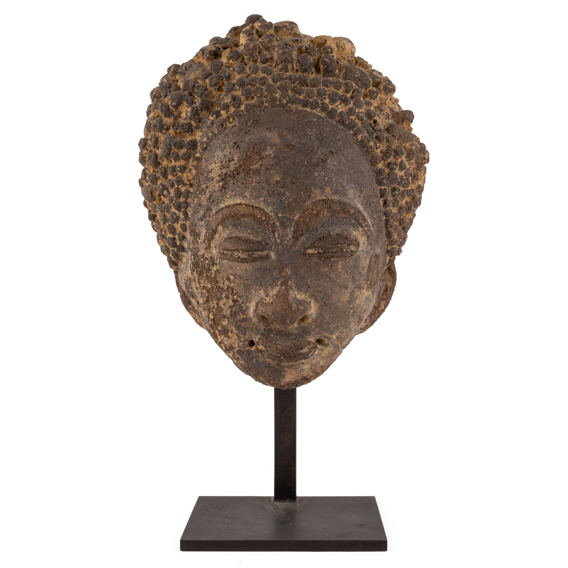 An antique African pottery head, possibly Akan, Ghana 15cm wide 20cm high Provenance A private