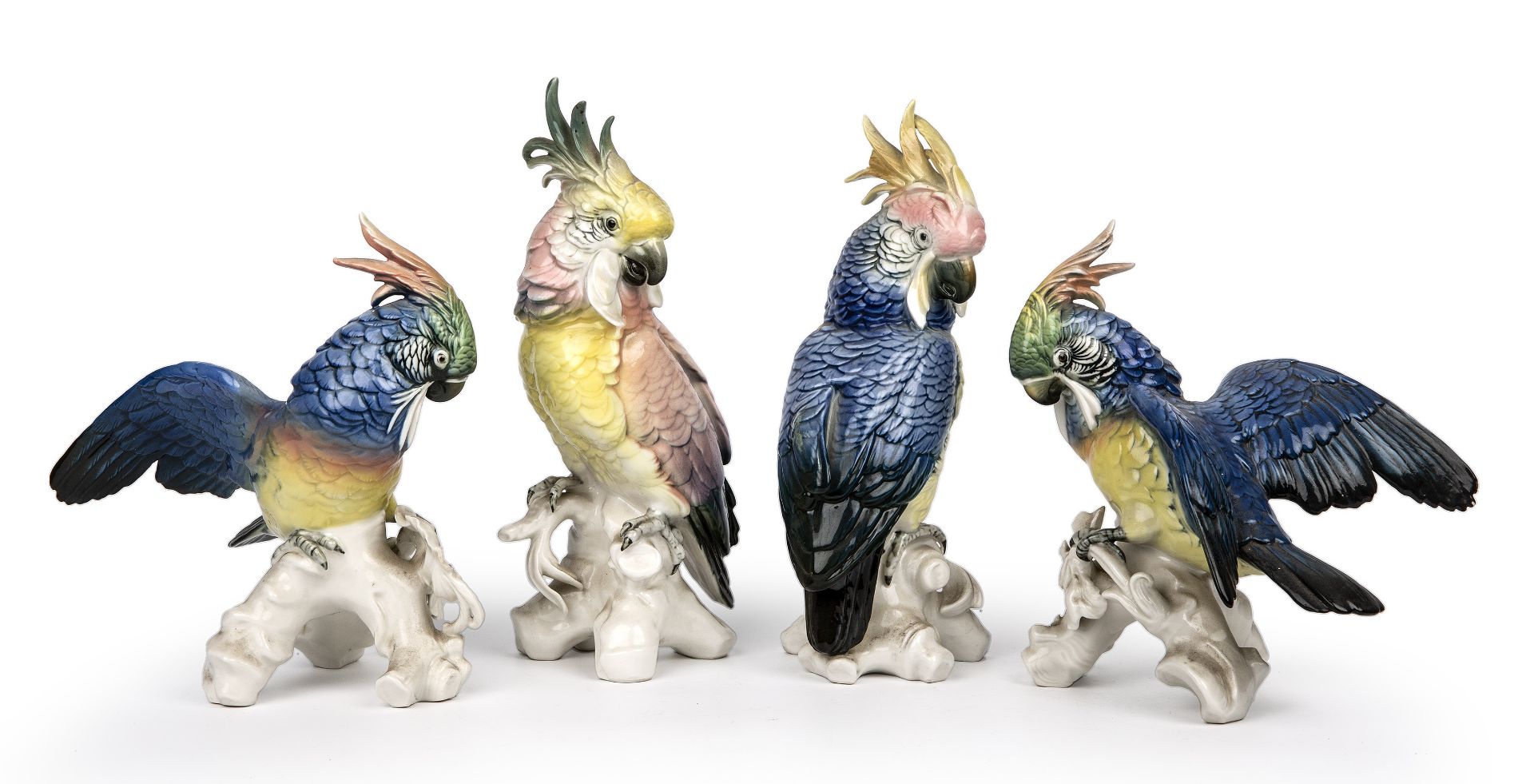 Four continental porcelain cockatoos, the largest 29cm high Bird A - chip to base branch,