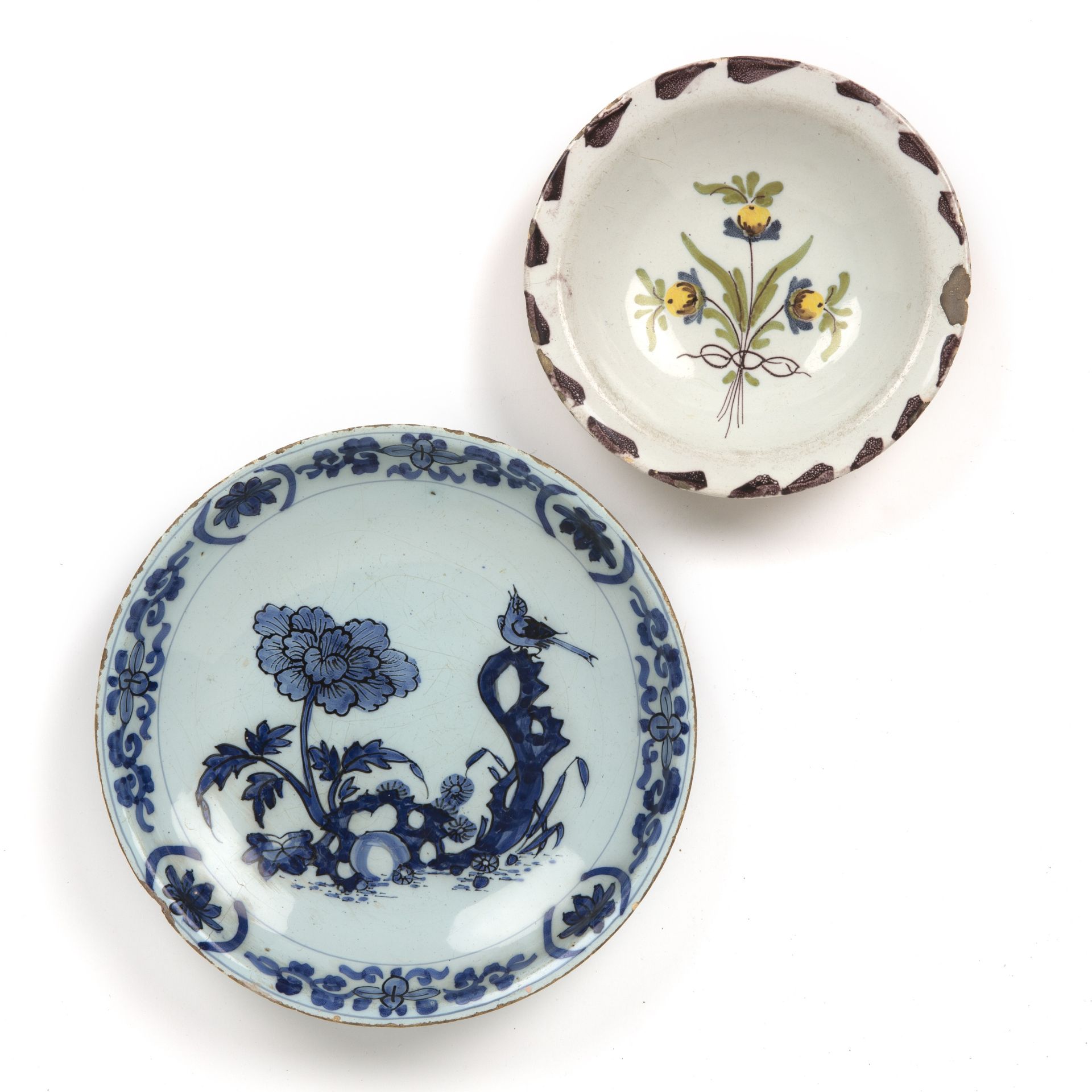 An early Dutch Delft saucer dish circa 1660-1680 21.5cm diameter together with a purple dash charger