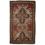 An early 20th century star Kazak rug with polychrome decoration and a banded border 130cm x 215cm