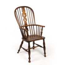 A 19th century ash and elm spindle back Windsor armchair with a pierced splat and turned supports,