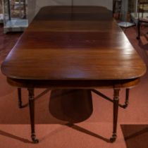 A George III and later extending dining table with reeded legs, brass castors and three leaves 312cm