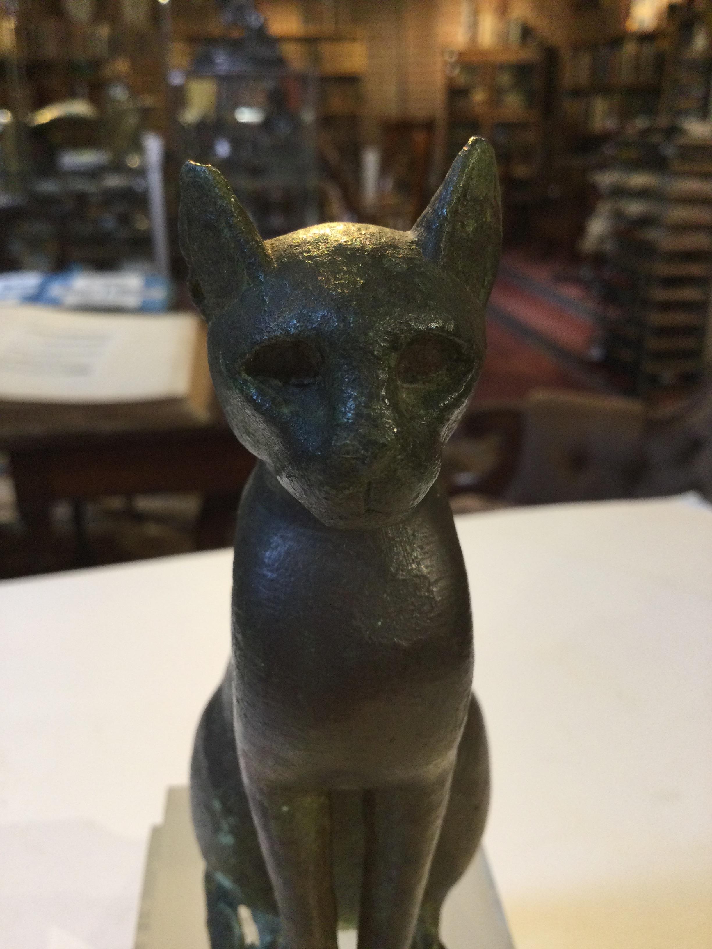 An Egyptian bronze cat figure , hollow cast, depicted seated and alert with forepaws together and - Image 23 of 26