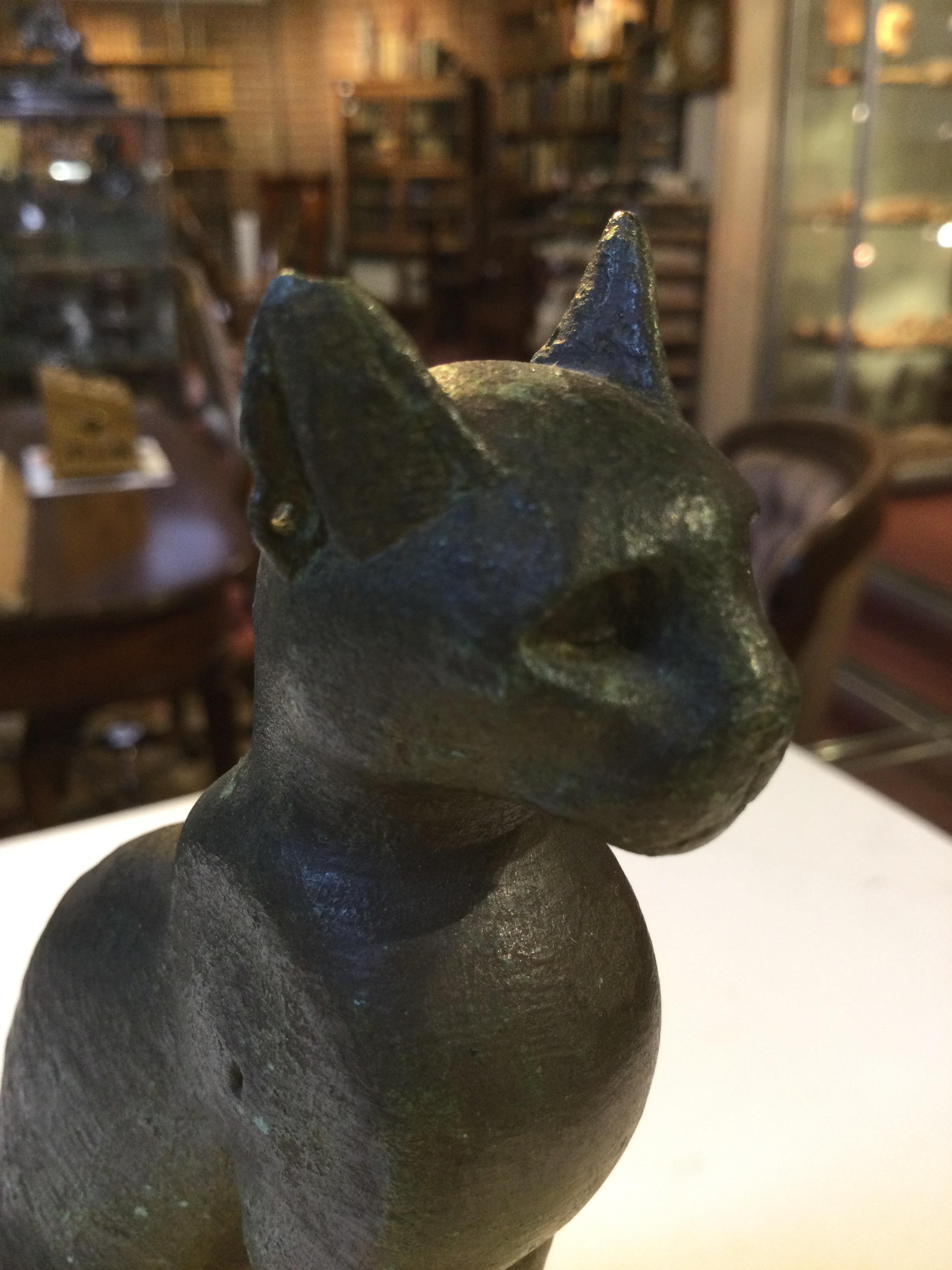 An Egyptian bronze cat figure , hollow cast, depicted seated and alert with forepaws together and - Image 24 of 26