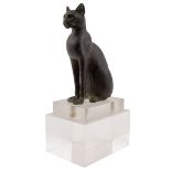 An Egyptian bronze cat figure , hollow cast, depicted seated and alert with forepaws together and