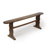 A 19th century elm bench with shaped ends united by a stretcher 140cm wide 32cm deep 47cm high