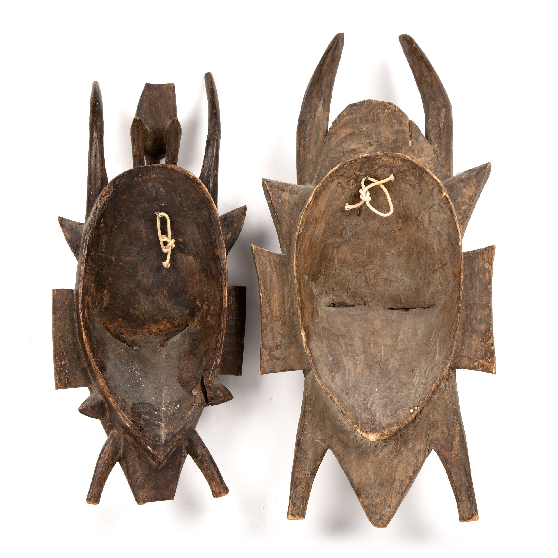 Two carved hardwood African masks, one with gilded decoration, the largest 29cm x 60cm - Image 2 of 2