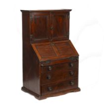 An 18th century elm apprentice bureau bookcase with panelled doors above a fall front three