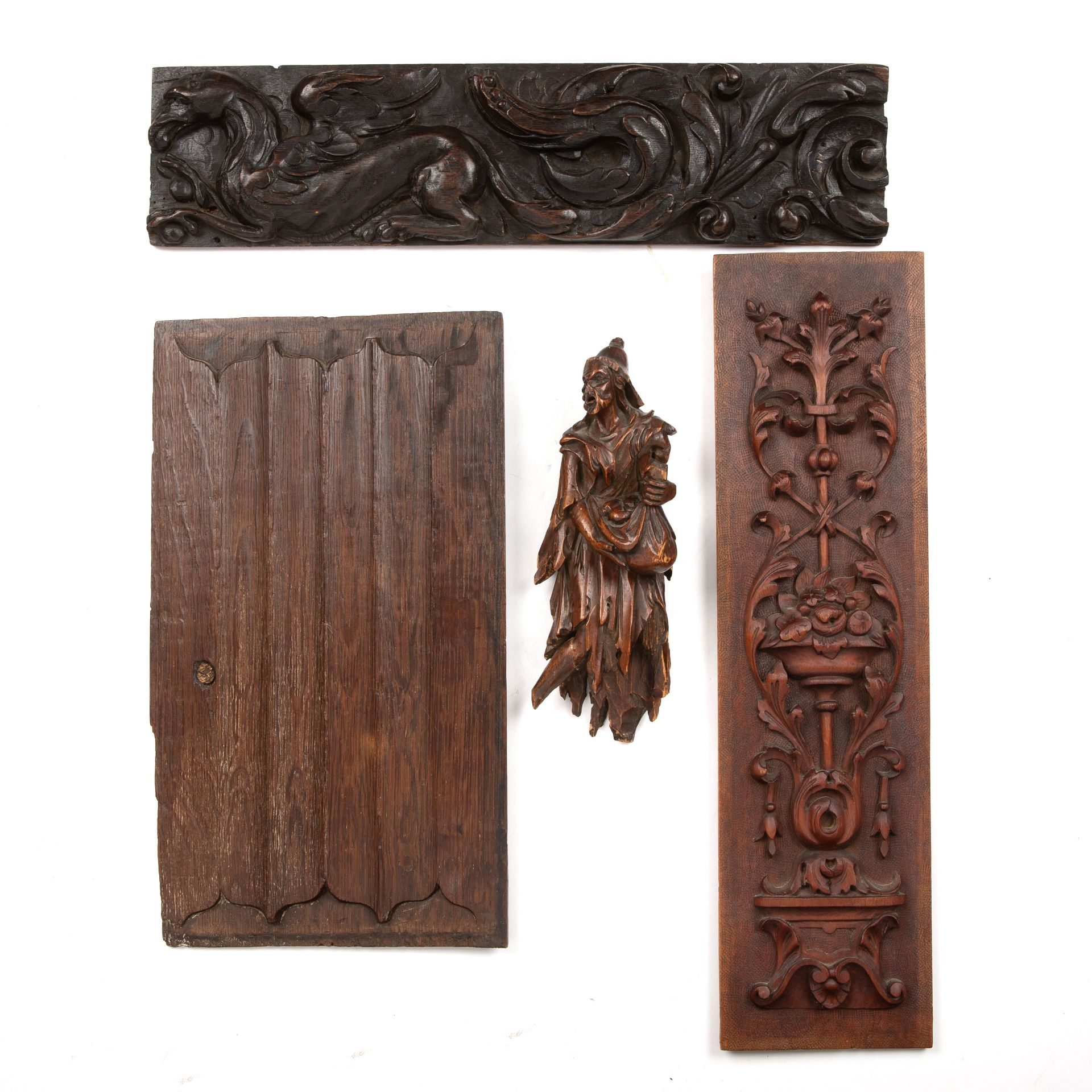 An 18th century carved softwood figure 24cm x 8cm together with three carved wood elements (4) The