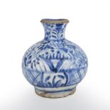 An early 18th century Meshed Kirman pottery bottle vase, with blue and white decoration 14cm wide
